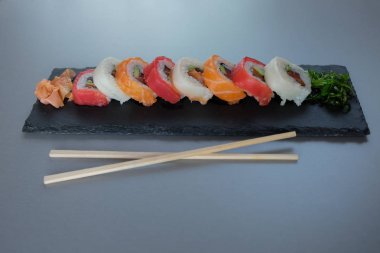 tabak çanak, Philadelphia rulo suşi somon, karides, avokado, krem peynir ile üzerinde suşi rulo. Sushi Menüsü. Japon yemekleri