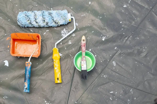 stock image Paint Roller in Orange Paint Bucket, Painting Tools