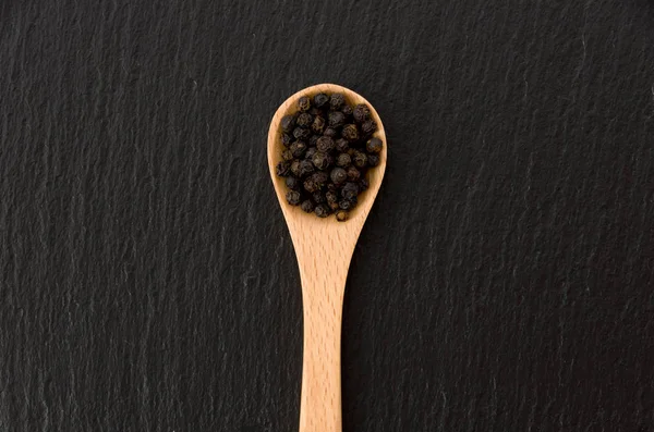 Wooden Spoon Black Pepper Black Stone Plate — Stock Photo, Image