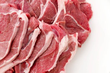 Raw lamb meat on a white plate on white background