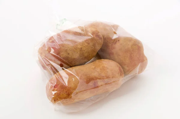 Fresh Red Skinned Potatoes Soil Plastic Bag White Background — Stock Photo, Image