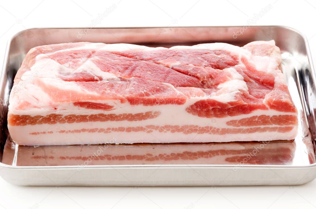 Raw Pork belly on a Stainless steel tray on white background. 