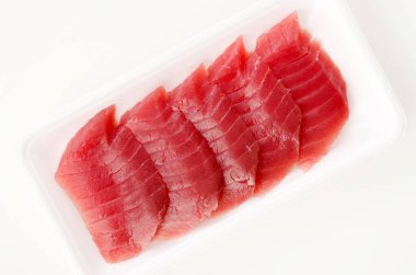 Beyaz arka planda taze çiğ ton balığı bifteği.