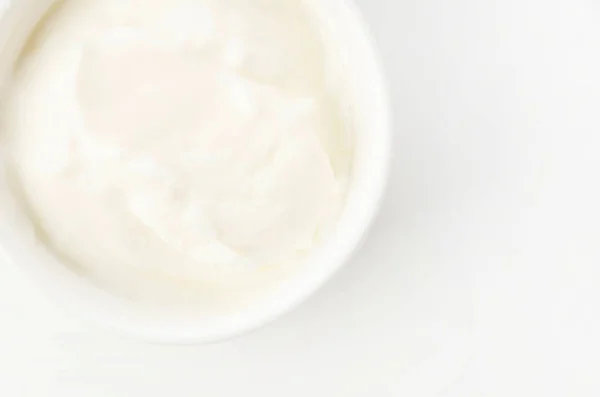 Fresh greek yogurt in Ceramic white Ramequin on white background