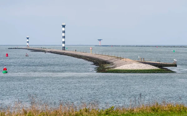 The entrance of the Port of Rotterdam in the Netherlands with dams and lighthouses,  seen from the Landtong near Rozenburg.