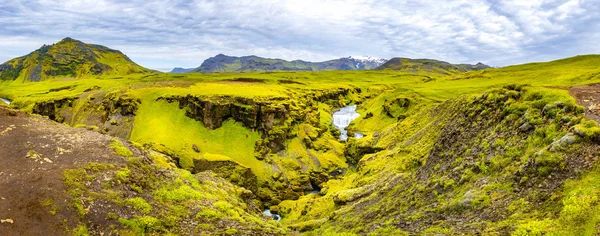 Panoramic view of cascade of small waterfalls near huge Skogarfoss waterfall on South Iceland, summer time, details
