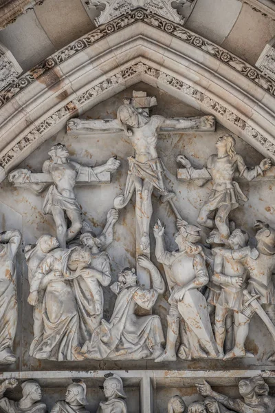 Crucifixion of Christ scene at major entrance portal of Saint Vitus Cathedral in Prague, Czech Republic