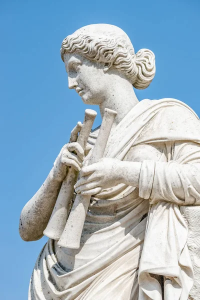 Ancient statue of a sensual renaissance era woman with musical i — Stock Photo, Image