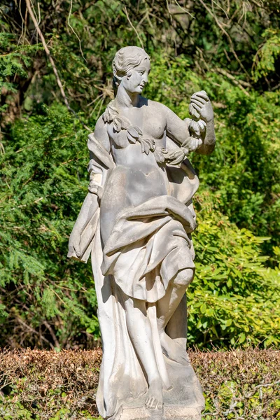 Ancient statue covered with moss and lichen of a sensual renaiss — Stock Photo, Image