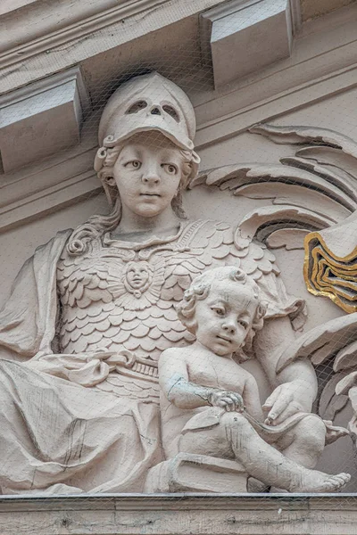 Bas relief sculptures of a woman with a child in the historical downtown in Potsdam, Germany, details, closeup