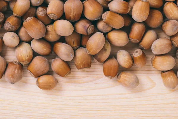 stock image Pile of nuts. Whole nuts. Corylus avellana. Macro photo, close up, top view on wooden table.