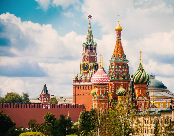 Colorfuil towers of Saint Basil's cathedral and Spasskaya Tower of Moscow Kremlin against amazing summer cloudscape