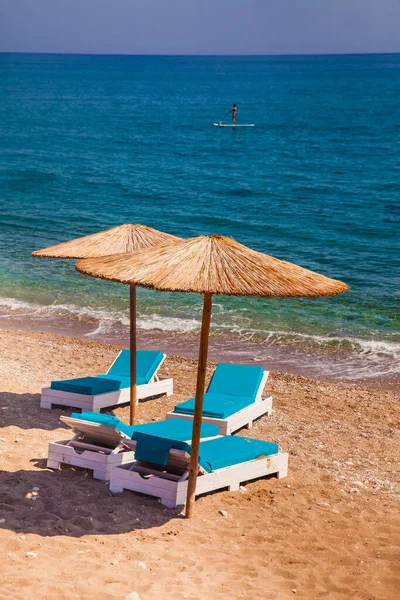 Пляж Двумя Пумбреллами Рядом Спокойной Зеленой Голубой Водой Неопознанные Места — стоковое фото