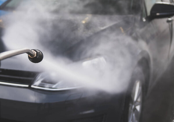 Car wash using high pressure water jet.