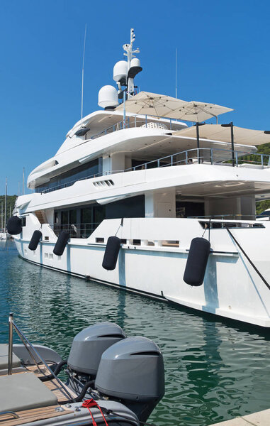 White luxury yacht moored in the bay.