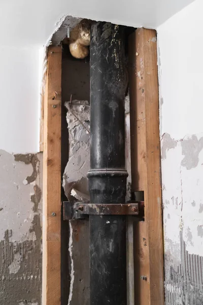 Preparation of repair the bathroom. Sewage pipe inside old soviet apartment.