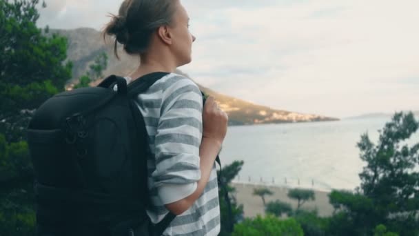 Woman with backpack near the sea coast. — Stock Footage Woman Backpack Sea Coast Stock Video