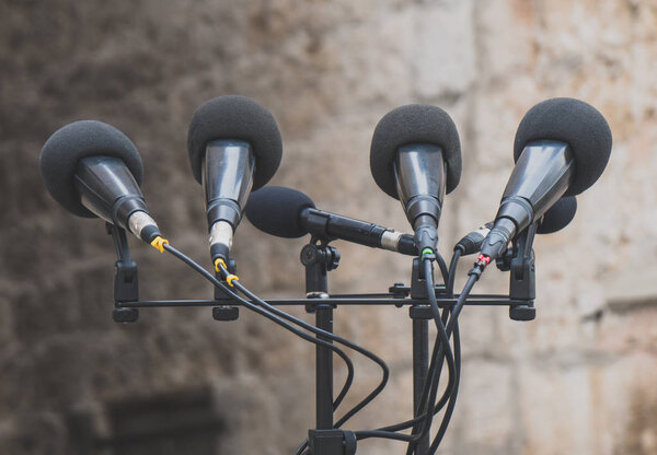 Microphones prepared for press conference on the street.