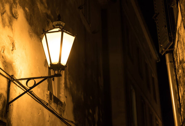 Vintage old lantern in the city at night.