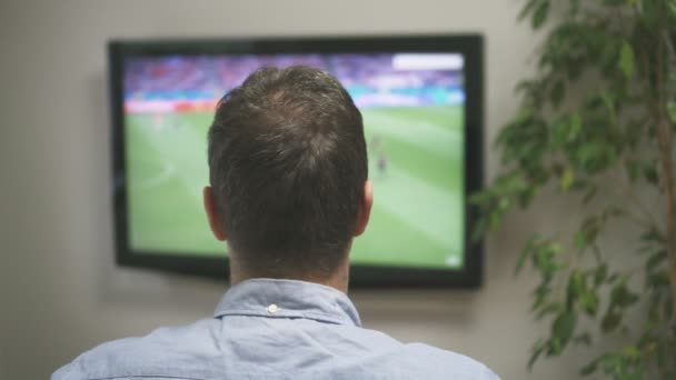 可悲的男人在家里的电视上看足球赛 — 图库视频影像