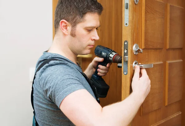 Young Handyman Uniform Changing Door Lock — Stock Photo, Image