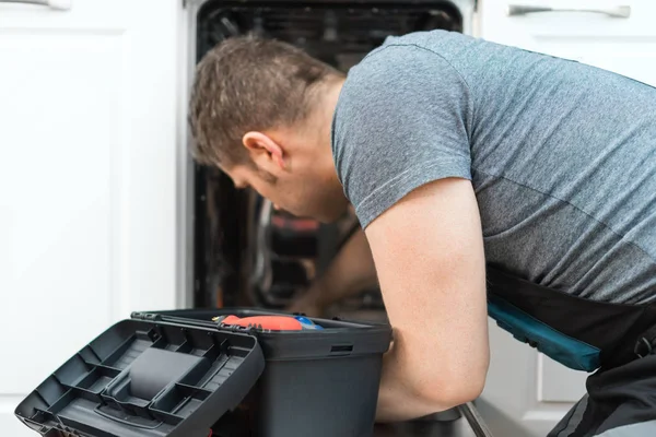 Professional Handyman Overalls Repairing Domestic Dishwasher Kitchen — Stock Photo, Image