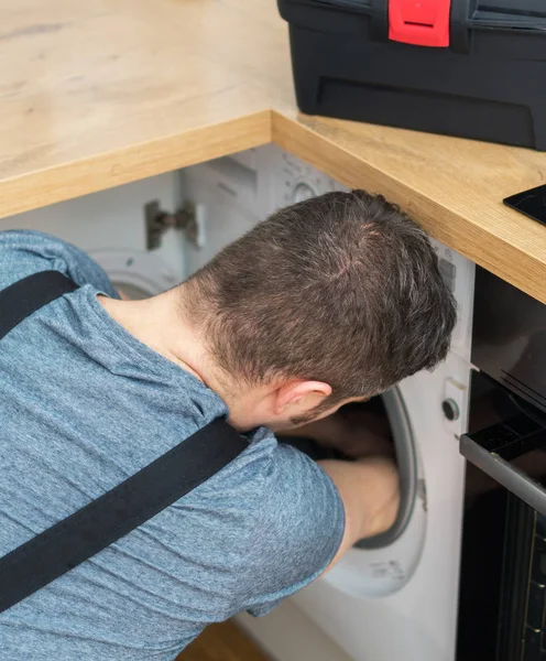 Professional Handyman Overalls Repairing Washing Machine Kitchen — Stock Photo, Image