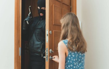 Little girl opening the door to the robber with gun. clipart