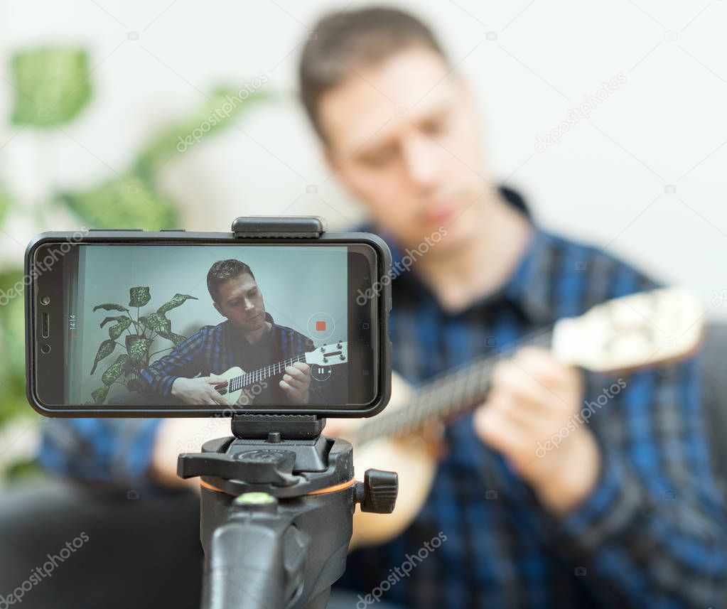 Handsome man recording song. Vlogging concept.
