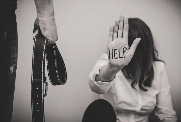 Un homme ceinturé arrive à sa femme. Concept de violence familiale  . — Photo