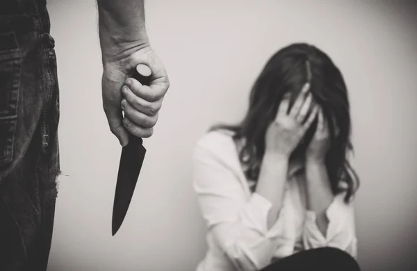 Man with knife coming to his wife. Home violence concept. — Stock Photo, Image