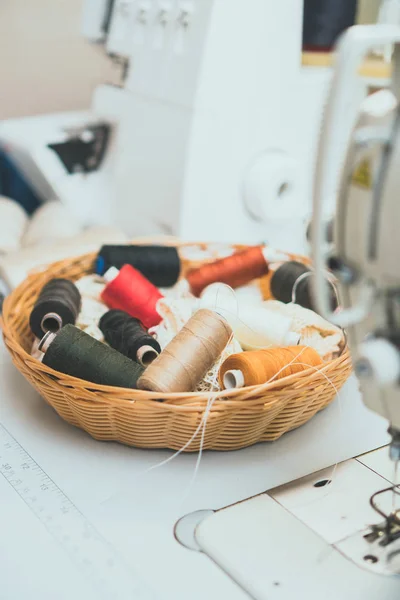 Sewing concept. Lot of thread coils next to the sewing machine. — Stock Photo, Image