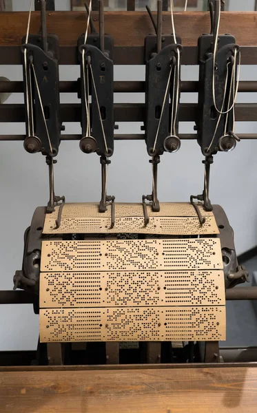 Binding machine. Used to sew together perforated cards for the Jacquard loom.