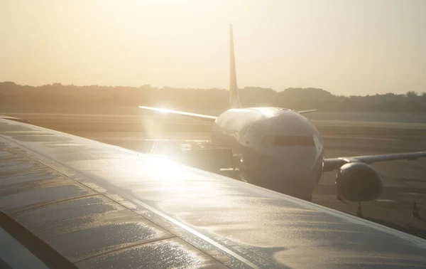 Part of airplane on the runway at sunset. — Stock Photo, Image