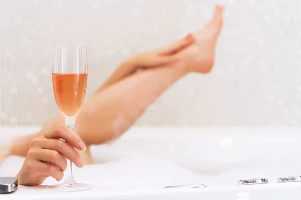 Kvinna med glas vin är avslappnande i badkaret. Utrymme för text. — Stockfoto