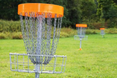 Disc golf basket in the park. clipart