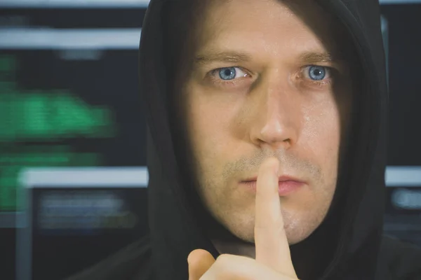 Handsome hacker in black hoodie. Hacking and internet security concept. — Stock Photo, Image