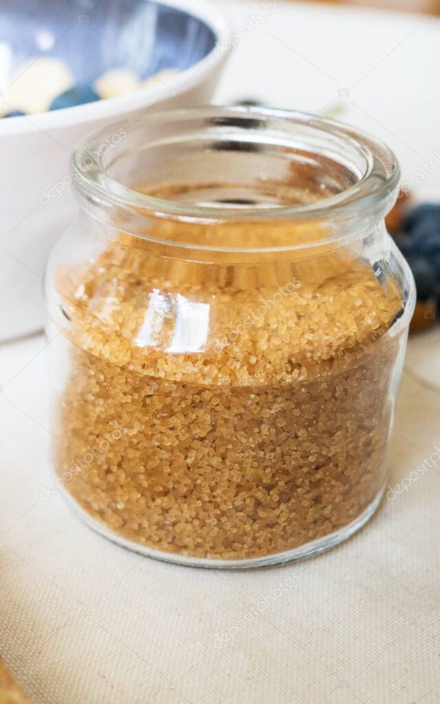 Brown sugar in the glass jar. Close-up view.