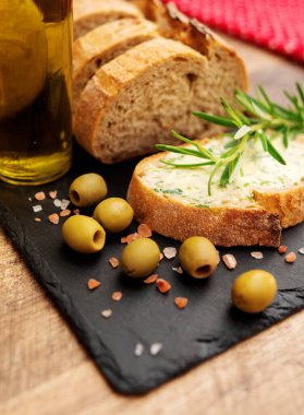 Masada dilimlenmiş ekmek ve el yapımı otlar var..