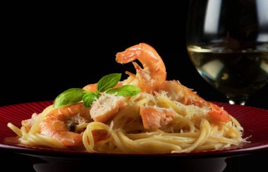 Kırmızı tabakta karides ve somonlu spagetti..