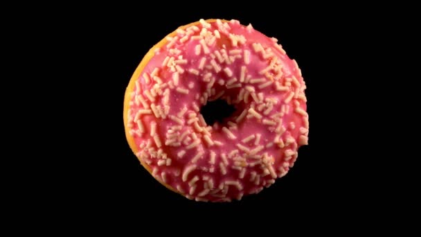 Fliegender Rosa Glasierter Donut Mit Streusel — Stockvideo