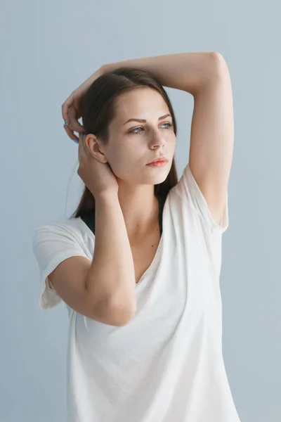 Retrato de una hermosa chica en el estudio sobre un fondo gris — Foto de Stock