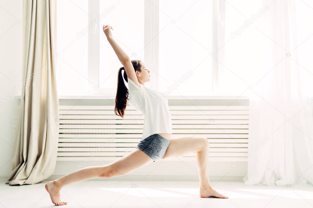 Young beautiful girl doing warm-up contemporary at home