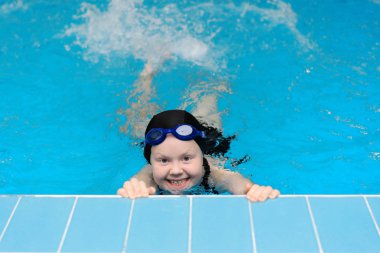 yüzme dersleri için çocuk havuzu - güzel tenli kız suda yüzüyor.