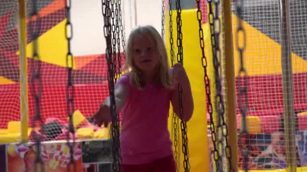 Happy childhood of a modern child in the city - the girl having fun in an amusement park — Stock Video