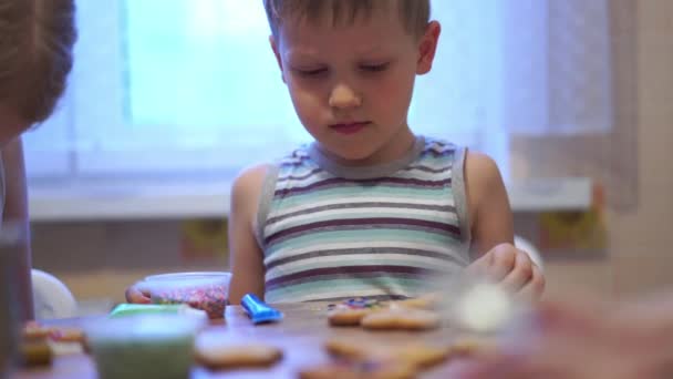 Home video - happy kids making cookies at home in the kitchen — Stock Video