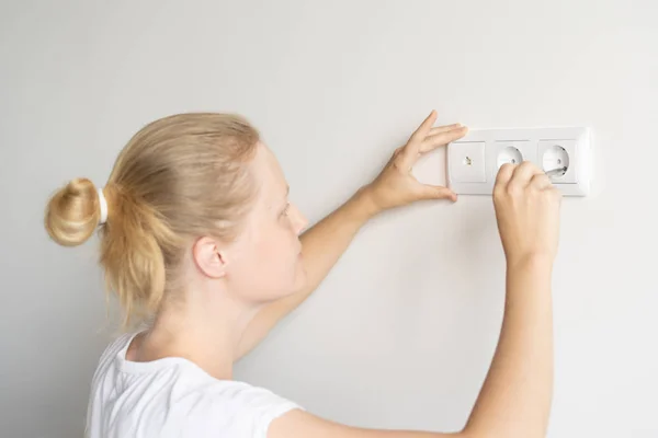non-female work. repair and decoration. woman repairs outlets in a new apartment