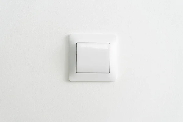 white modern light switch on white wall