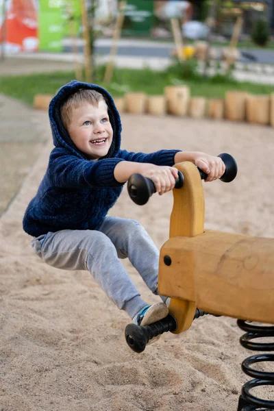A little boy is having fun playing on the modern urban European playground — Stock Photo, Image