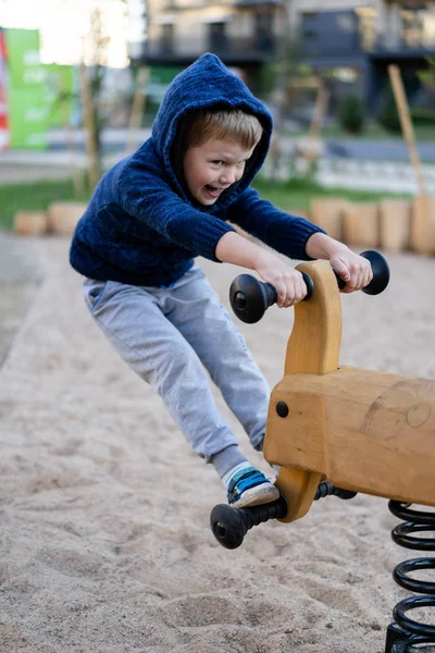 A little boy is having fun playing on the modern urban European playground — Stock Photo, Image